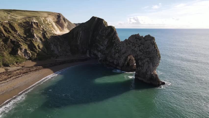 Mesmerizing drone view of Durdle Door, limestone arch, famous landmark attraction on Dorset's Jurassic Coast, UK