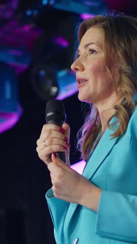 A speaker on stage captivates the audience with an inspiring speech at the International Business Conference. The event features discussions on innovation and leadership