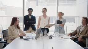 A diverse group of young, successful business people having a meeting in a modern office, showcasing teamwork and collaboration amidst an atmosphere of innovation and corporate productivity - Powered by Shutterstock - Get 15% off with code: PIKWIZARD15