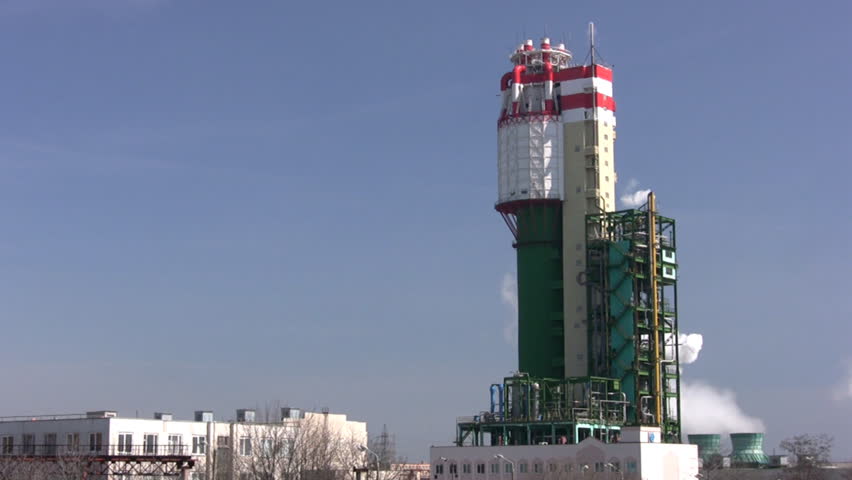 Clear day. Industrial building produces white smoke