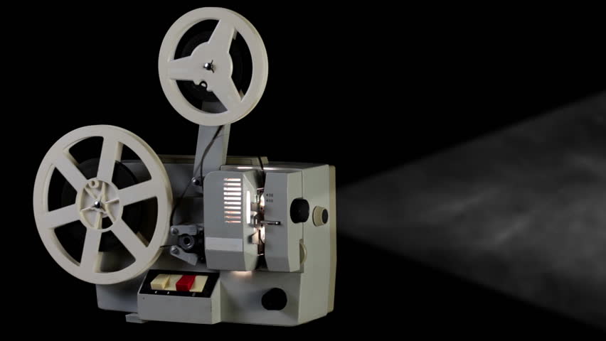 Black studio. Cinema projector rewinds reels with 8mm films. A lot of smoke and