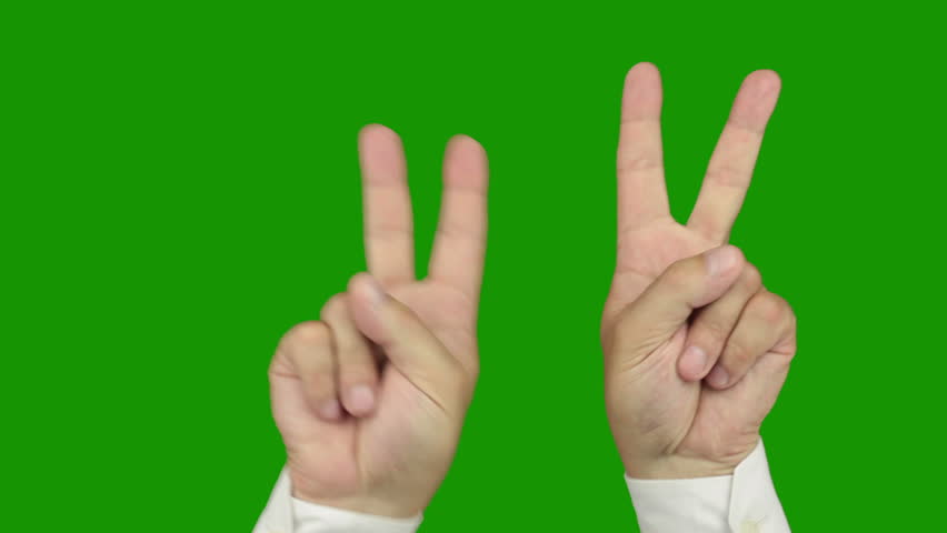 Green background (Chroma Key). Men's hands in a white shirt making the hand sign