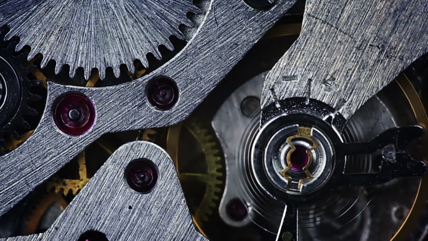 The pendulum and gears of the old watch on the move. Close-up. The focus in the