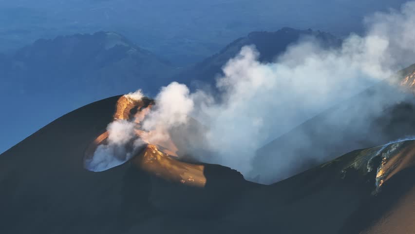 Strombolian activity from the Voragine on Etna. Explosions, lava. July 2024 Etna active on the summits. Sunset. Wells with gas emission. North East and South East Crater with Bocca Nuova.
