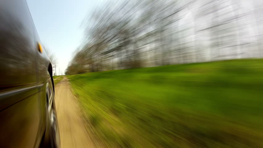 Spring. The car was going fast down a country road. At first the road in a
