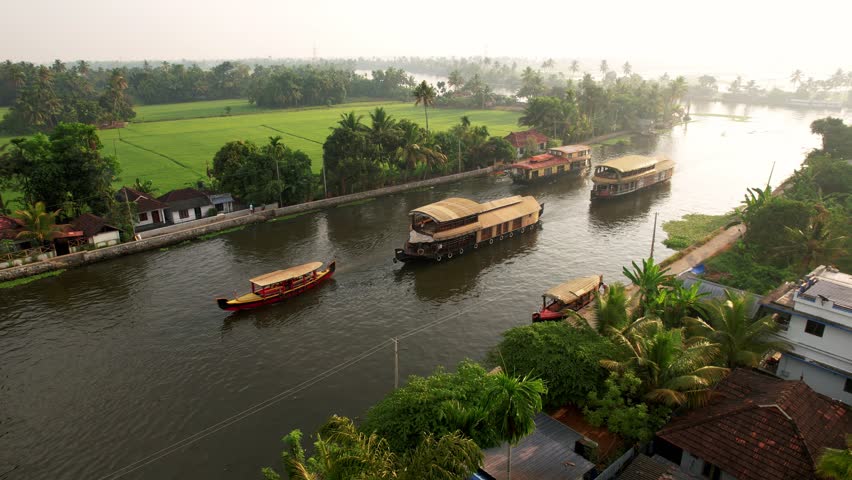 Houseboats in Kerala, Aerial view, Alleppey India. Travel along the canals with palm trees growing along the shores of Kerala. Concept of vacation.