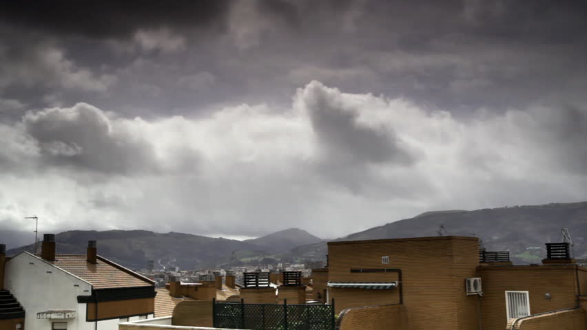 view of the top of the houses with storm clouds time lapse