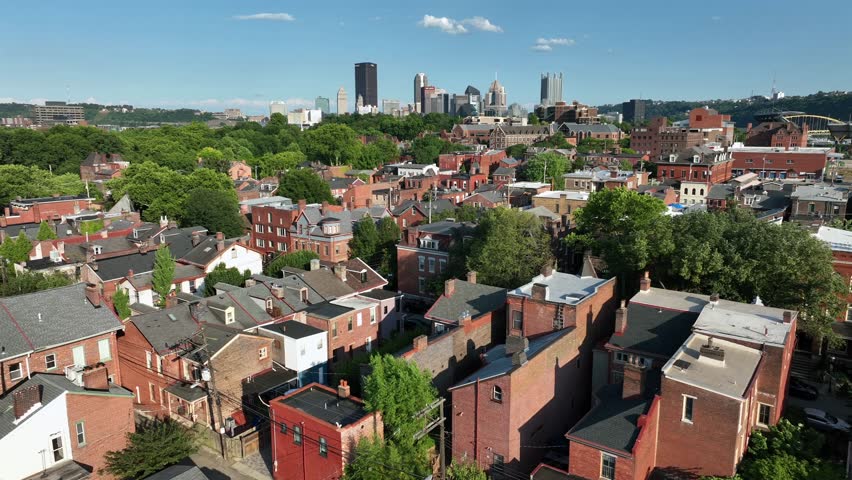 Historic brick rowhouses in Pittsburgh neighborhood. Aerial view of housing near downtown city in Pennsylvania during summer.