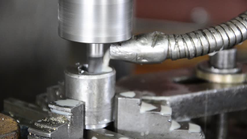 Industrial CNC machine milling some steel part