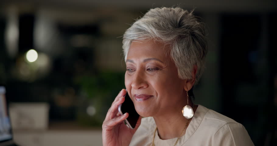 Phone call, mature woman and talking with smile, night and working late ...