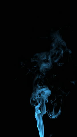 Real blue smoke from incense on black background, smoke overlay in slow motion. Close up.