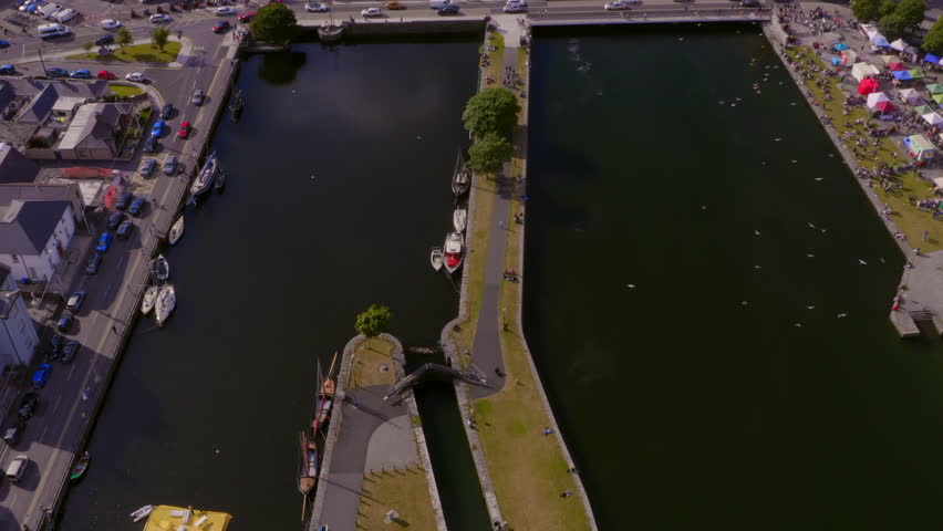 Busy Galway city center during the arts festival. Aerial top-down view of the River Corrib.