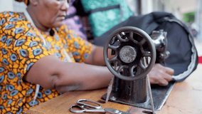 Close-up of an african woman using manual sewing machine - Powered by Shutterstock - Get 15% off with code: PIKWIZARD15