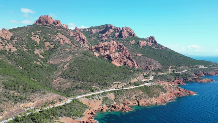 A beautiful view of Massif de l'Esterel Mountain range in France by the sea and blue sky