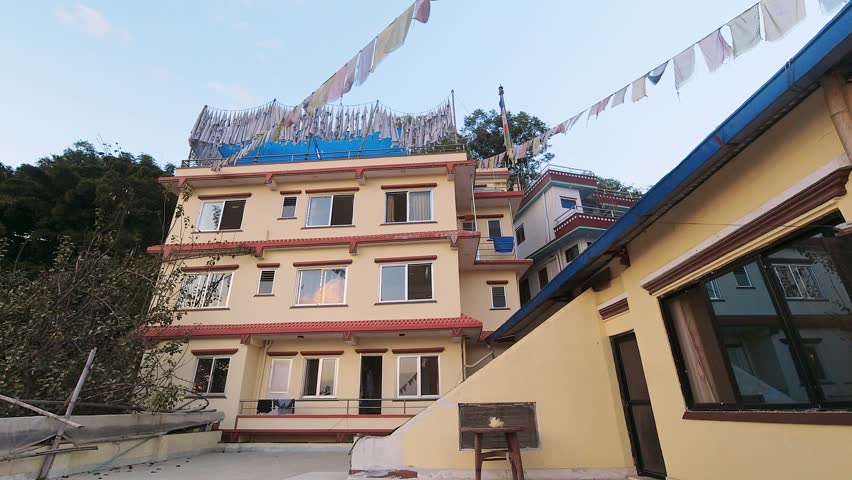 Close up traditional residential nepalese multiple floor guesthouse in Kathmandu capital city in Nepal. Accommodation and property in Nepal. Copy space building view with window on rooftop terrace