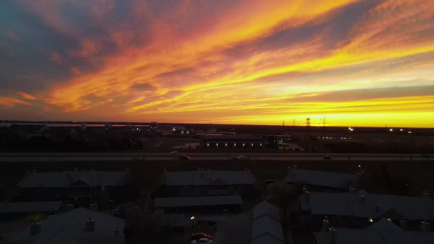 Lake Hefner Pkwy At Golden Hour Sunset In Oklahoma City, Oklahoma. Lake Hefner And Water Treatment Plant In Background. aerial ascend