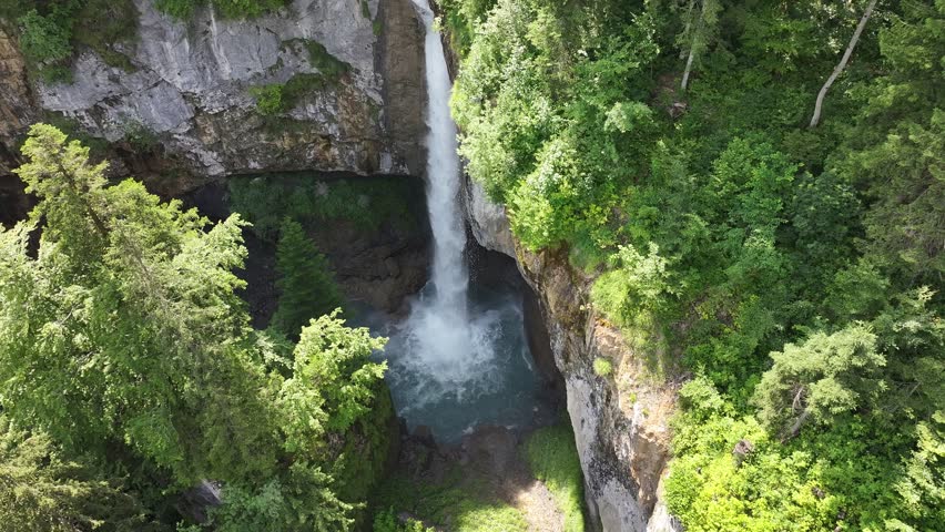 Drone view of the Berglistüber waterfall. Falling water in a beautiful overgrown green nature. Glarus Süd region in Switzerland.