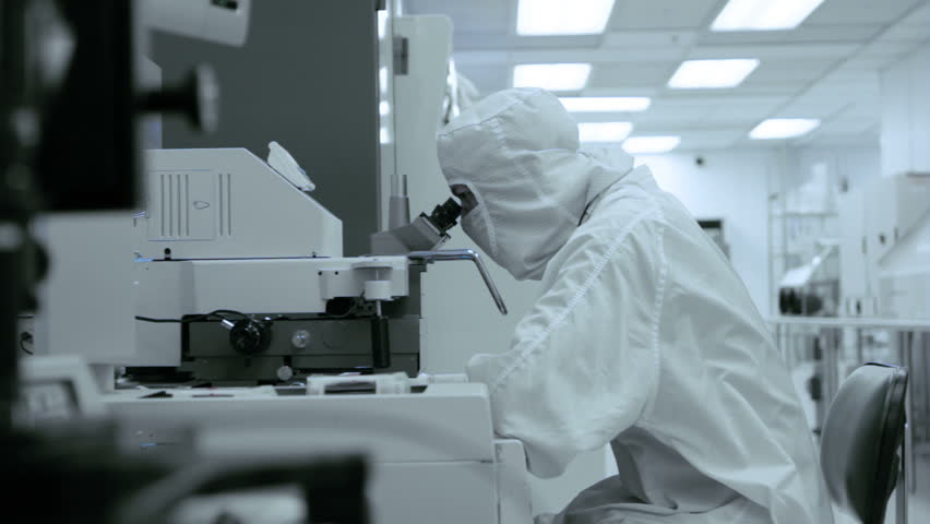 Clean Lab Microscope.  Technician checking a photographic process while working