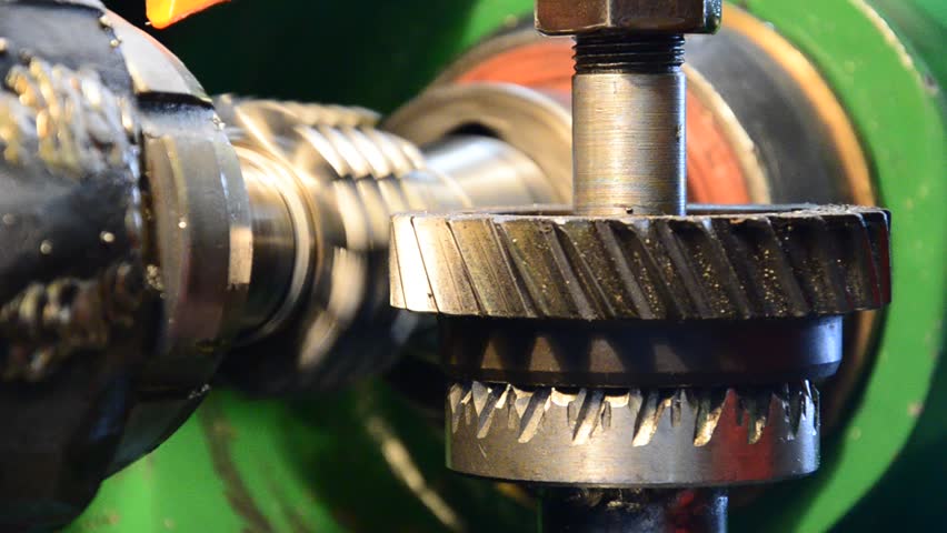 cogwheel production and service industrial machine, rotating gears closeup view