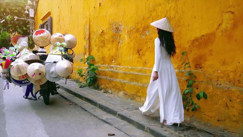 Asian woman wearing vietnam culture traditional walking at Hoi an, Vietnam. Translation: "Hoi An tourism".