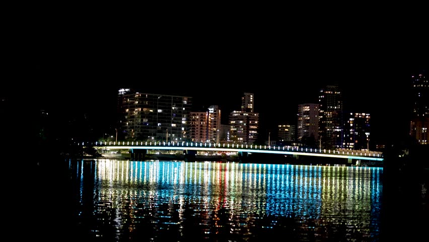 City lights reflecting on water at night