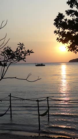 Island sunset with hammocks and silhouettes 