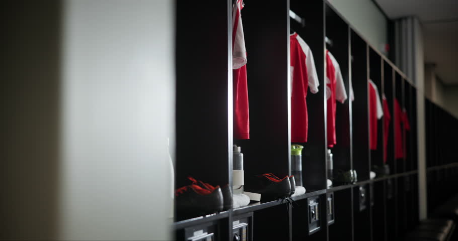 Change, interior and empty locker room with sport jersey, water bottle and fitness equipment. Soccer, gym and uniform at club with clothes, shoes and football cleats in dressing closet for storage
