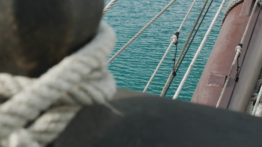 view from the deck of an 18th century Spanish sailing ship of the bowsprit mast facing the coast of a city. Spanish historical ship, maritime life and navigation