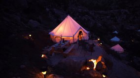 Woman Going From Illuminated Yurt Tent in Glamping Area, Landscape of Utah USA - Powered by Shutterstock - Get 15% off with code: PIKWIZARD15