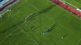 Aerial high angle top down shot of football players during practice. Soccer drills seen from above. Green football field with young men improving their skills. High angle sports training at a stadium. - Powered by Shutterstock - Get 15% off with code: PIKWIZARD15