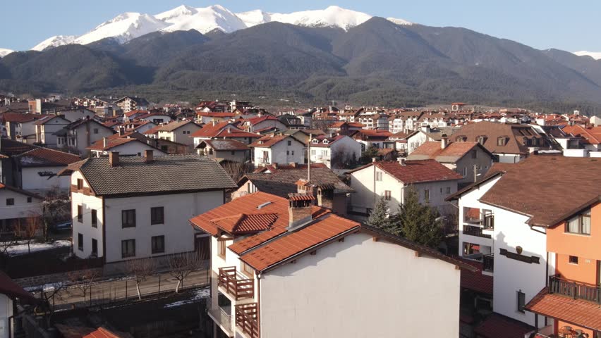Scenic Winter View of Mountain Town With Snow-Capped Peaks