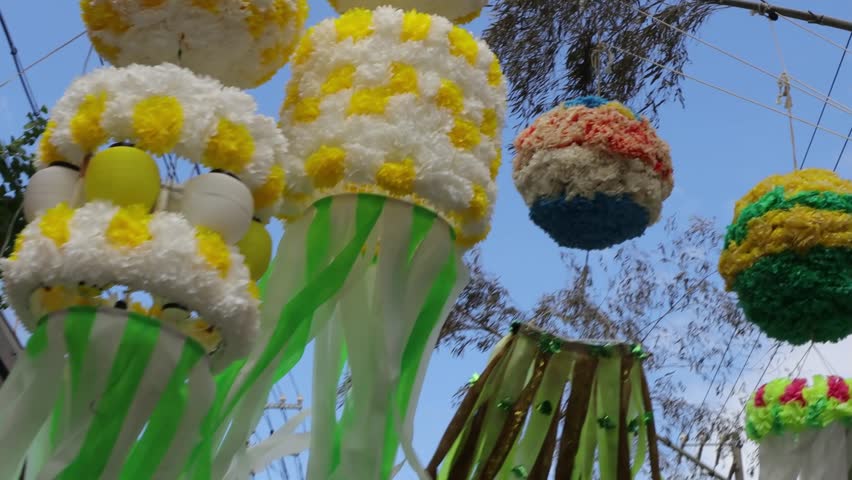 Colorful streamers swaying in the wind on the morning of a summer festival. At summer festivals held all over Japan, the streets are decorated with festive decorations that are lit up at night.