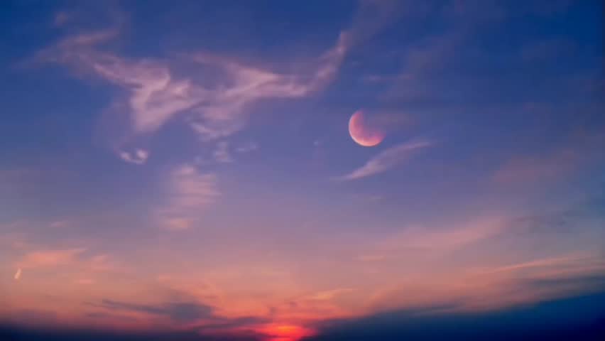 Cloudy skies in the afternoon transitioning to evening with a very beautiful moon creating a serene atmosphere