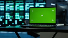Focus on green screen laptop used by engineers in high tech data center to monitor security threats. Close up of mockup notebook used by workers ensuring compliance with regulations, camera A - Powered by Shutterstock - Get 15% off with code: PIKWIZARD15