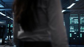 Engineer in data center sitting down at desk, installing software on computer, troubleshooting issues. Woman arriving at work in server hub, establishing performance benchmarks, camera B - Powered by Shutterstock - Get 15% off with code: PIKWIZARD15