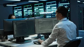 Coworkers in high tech data center monitoring security threats, implementing cybersecurity measures. IT staff members ensuring compliance with server room workspace regulations - Powered by Shutterstock - Get 15% off with code: PIKWIZARD15