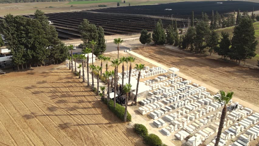 drone shot a Jewish cemetery.
Rural tranquility at a small cemetery nestled among farmlands, in southern Israel
Religious Jews in traditional dress Praying on the memorial day.