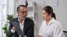 Businesswoman and senior colleague collaborate with a digital tablet in a modern office. Sharing ideas and discussing strategies in a professional setting - Powered by Shutterstock - Get 15% off with code: PIKWIZARD15