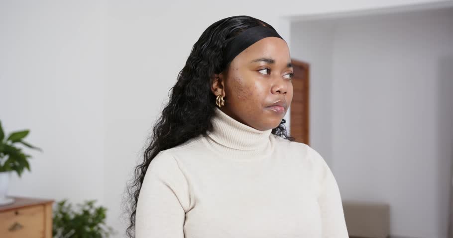 High speed photography for dynamic scenes, smiling woman wearing turtleneck sweater looking away in bright indoor setting. people, movement, face, turning head