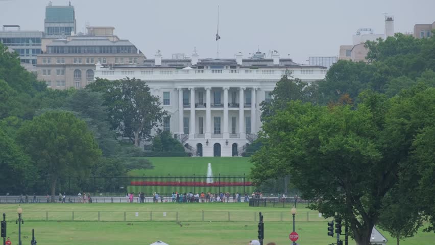 A vibrant day in D.C. at the White House, with visitors and greenery