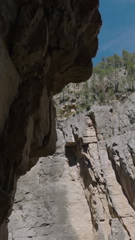 Walking in the mountains of Montserrat in Spain in summer. Panorama of mountain peaks and green plants against the blue sky. Trails for active recreation