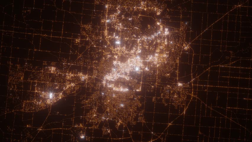 Fort Wayne (Indiana, USA) aerial view at night. Top view on modern city with street lights. Camera is zooming out, rotating clockwise