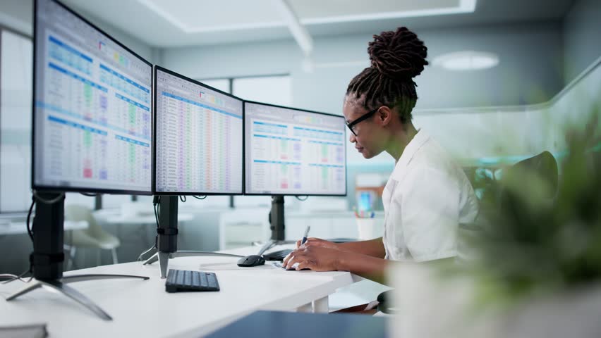 Hospital Doctor Using Spreadsheet For Billing Codes On Desktop