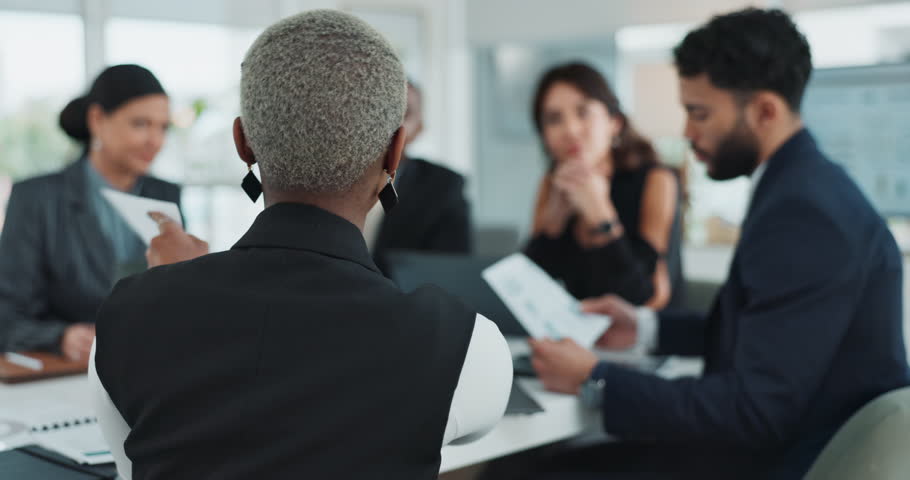 Back, business woman and question in office with team brainstorming or planning with paperwork. Group, asking and hand raised for answer with leader for project report with sales manager in meeting