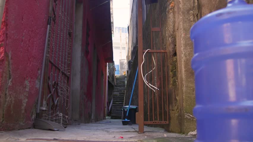 Favela stairs, huge bottle of water, broom, lose wires, slums of Sao Paulo, Brazil.
