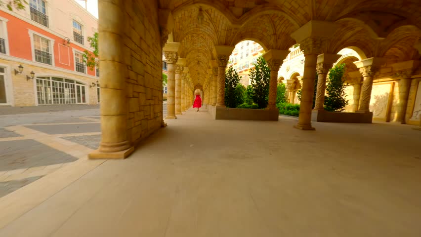 Dynamic FPV shot of woman traveler in Vietnamese hat exploring Sunset Town on Phu Quoc Island, Vietnam. Concepts of Vietnam travel, tourism, and adventure.
