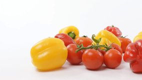 tomatoes and bell peppers on a white background