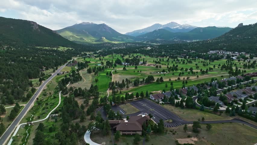 Aerial overview above golf course in Estes Park Colorado, panoramic drone