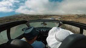 Couple driving convertible together along beach, Santorini Island, Greece - Powered by Shutterstock - Get 15% off with code: PIKWIZARD15