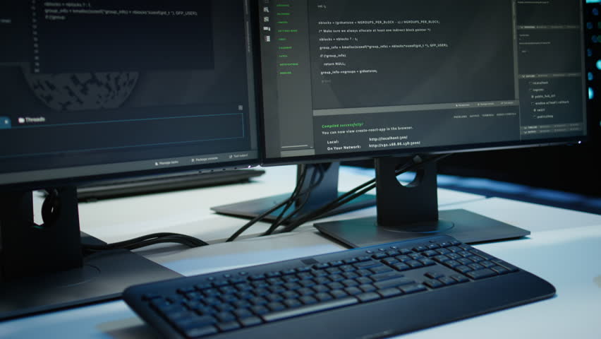 High tech data center with networking systems installed used for managing rackmounts gear. Close up of code running on computers in modern server room used for overseeing equipment, panning shot